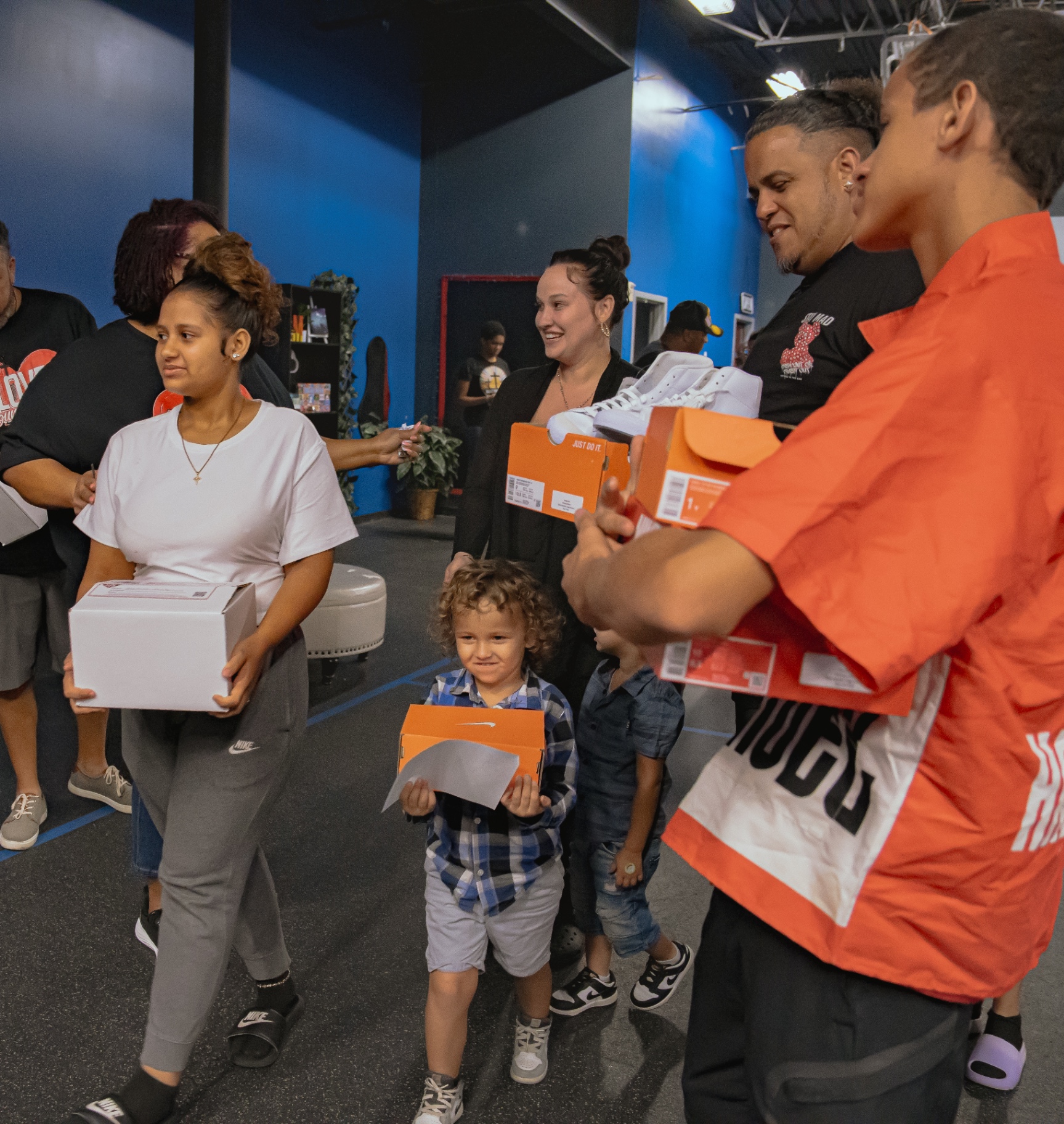 Family receiving sneakers at Sneaker Sunday 2025