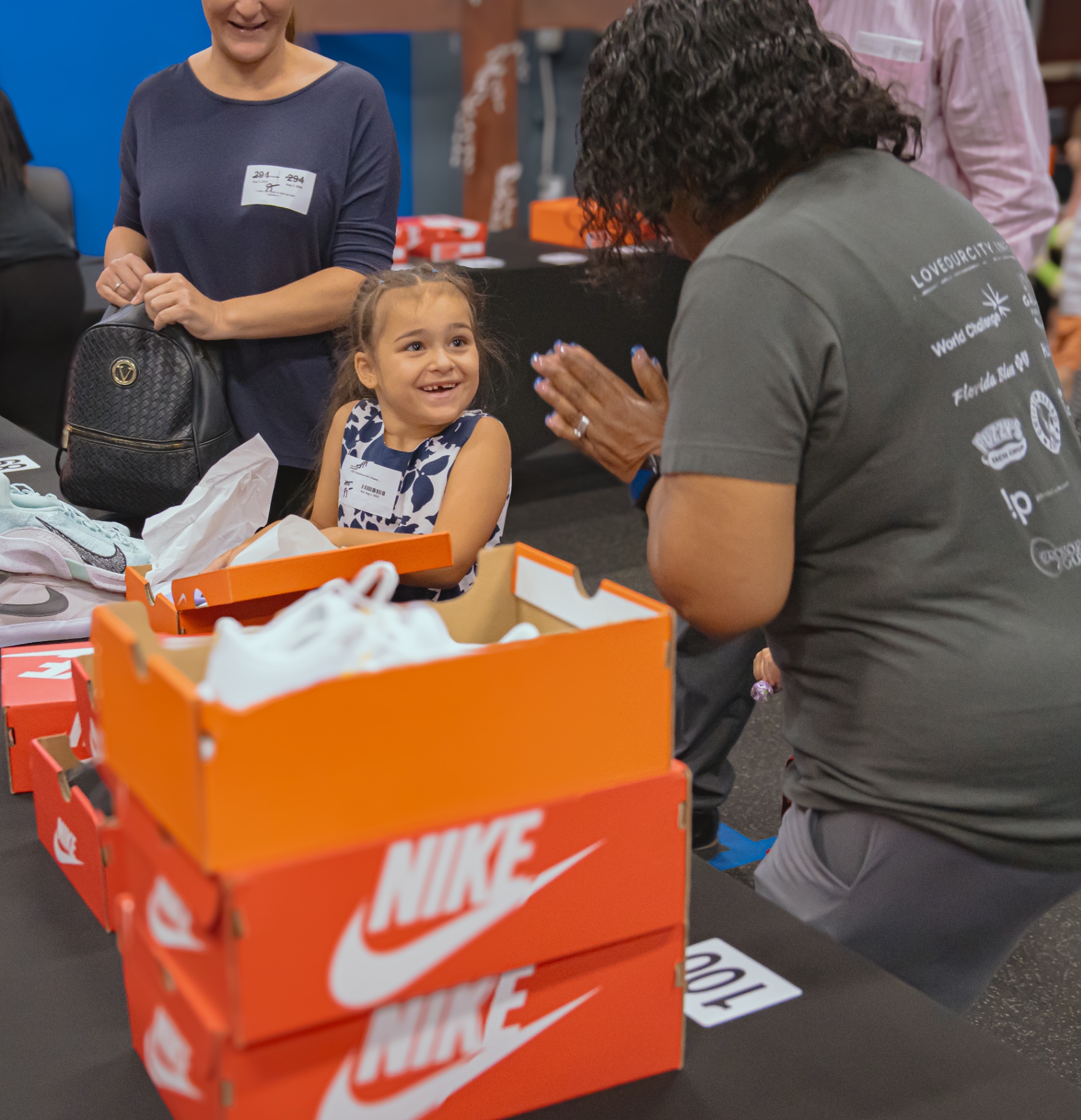 Child receiving new sneakers at Sneaker Sunday